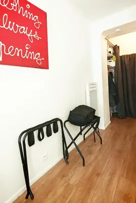 a room with a chair and a sign on the wall at Studio centre historique 200 m de la mairie - Climatisé in Aix-en-Provence