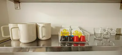 a counter top with several mugs and bottles on it at Studio centre historique 200 m de la mairie - Climatisé in Aix-en-Provence