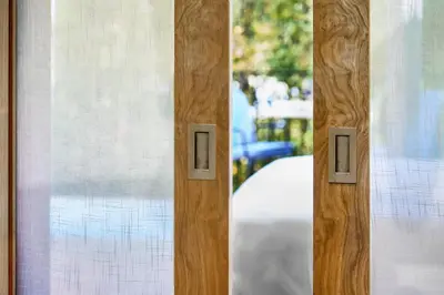 a close up of a glass door with a window at Auberge La Coste in Le Puy-Sainte-Réparade