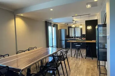 a dining room with a large wooden table and chairs at LA VILLA 81 in Mormoiron