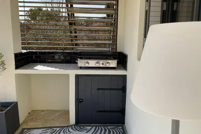 a kitchen with a stove top oven next to a window at LA VILLA 81 in Mormoiron