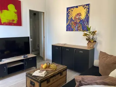 a living room with a television and a table with fruit at T3 centre ville Historique in Aix-en-Provence