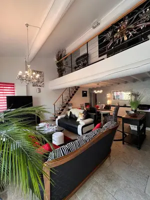 a living room with a couch and a loft at Villa en Provence, Spa & piscine, pour 9 personnes- Gîtes les Estelles in Cavaillon