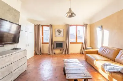 a living room with a couch and a flat screen tv at Authentique Appartement Aixois in Aix-en-Provence