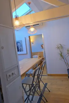 a kitchen and dining room with a table and chairs at Isabelli Appartement plein centre avec place de parking in Aix-en-Provence
