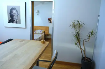 a dining room with a wooden table and a potted plant at Isabelli Appartement plein centre avec place de parking in Aix-en-Provence