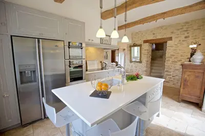 a kitchen with a large white island in a kitchen at Authentique propriété in Bonnieux