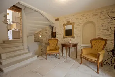 a living room with two chairs and a table at Authentique propriété in Bonnieux