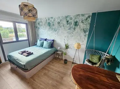a bedroom with a bed and a swing at 104 Douce Provence au calme face à la piscine in Éguilles
