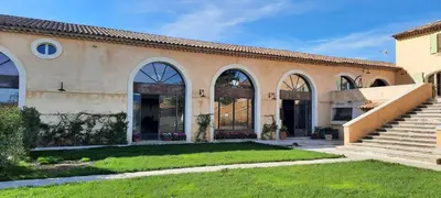 a building with large windows and a grass yard at Domaine des Francobelges - Appartements in Lauris