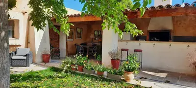 a house with a patio with plants and chairs at Domaine des Francobelges - Appartements in Lauris