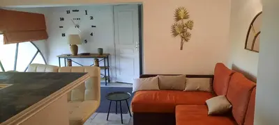 a living room with a couch and a table at Domaine des Francobelges - Appartements in Lauris
