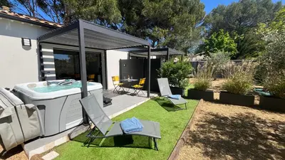 a backyard with a hot tub and two chairs at Pause spa sur la route du Ventoux adults only in Carpentras