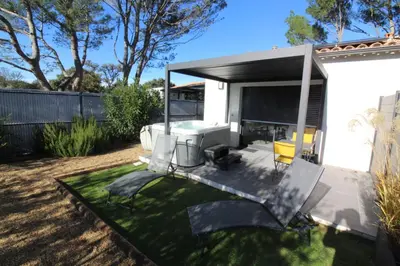a backyard with a patio with a table and chairs at Pause spa sur la route du Ventoux adults only in Carpentras