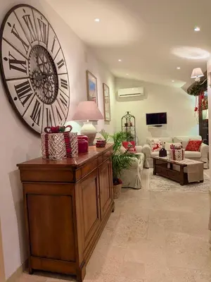 a living room with a large clock on the wall at LUBERON SOLEIL ET OLIVIERS in Les Taillades
