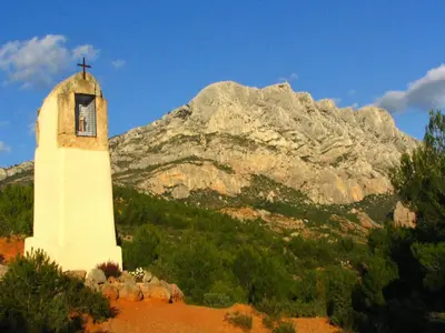 a church tower with a mountain in the background at Bliss Near Aix-en-Provence in Venelles