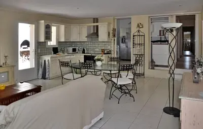 a kitchen and living room with a table and chairs at La Villa Du Soleil in Lacoste