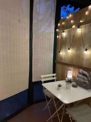 a table and chairs in a room with windows at Charming Studio to Venelles 10 minutes from Aix in Venelles
