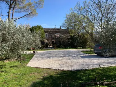 a car parked in a parking lot in front of a house at le mas du lavoir in Gordes