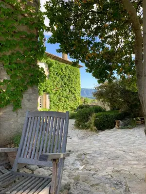 a wooden bench sitting in front of a building at le mas du lavoir in Gordes