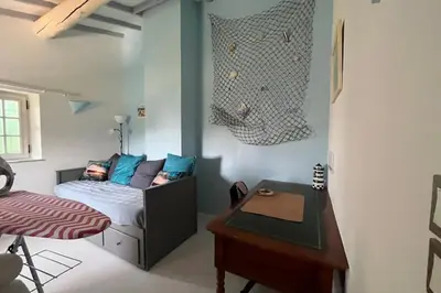 a bedroom with a bed and a desk in it at 84A - 