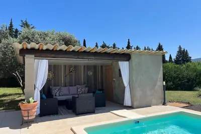 a pergola with a couch and a swimming pool at 84A - 