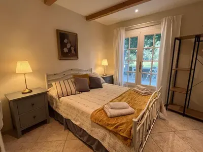a bedroom with a large bed and a window at The Garden View in Le Thor