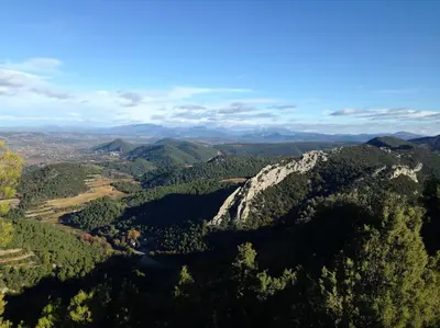 an aerial view of a mountain valley with trees at The Garden View in Le Thor
