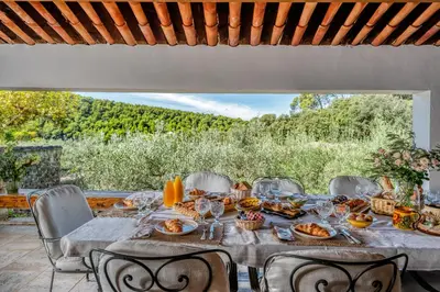 a table with food on top of a patio at Domaine de Valloncourt in Cheval-Blanc