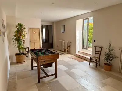a room with a foosball table and chairs in it at Domaine de Valloncourt in Cheval-Blanc