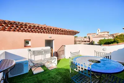 a patio with a table and chairs on the grass at Village Pont Royal en Provence - maeva Home - Appartement climatisé 3 pièces 4 personnes avec terrasse aménagée - Prestige - super Home MAE-3084 in Mallemort