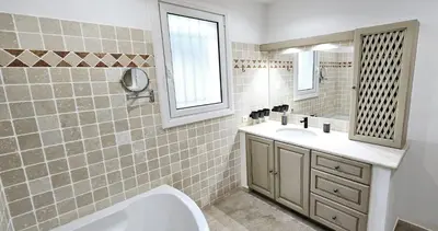 a bathroom with a tub and a sink and a mirror at Lou Mas dou Souleou & Spa in Cheval-Blanc