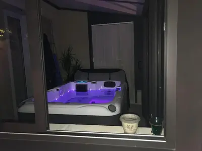 a reflection of a purple bed in a window at Lou Mas dou Souleou & Spa in Cheval-Blanc