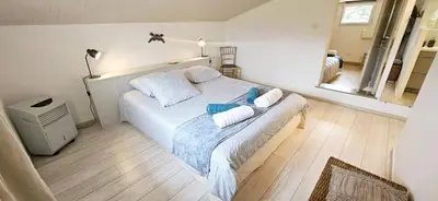 a bedroom with a bed with two pillows on it at Lou Mas dou Souleou & Spa in Cheval-Blanc