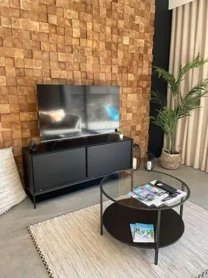 a living room with a tv and a coffee table at L'Artiste - Villa 5 min du centre historique d'Aix in Aix-en-Provence