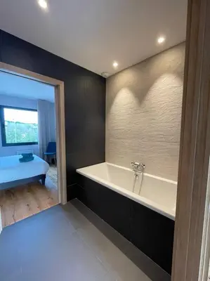 a bathroom with a bath tub in a room at L'Artiste - Villa 5 min du centre historique d'Aix in Aix-en-Provence