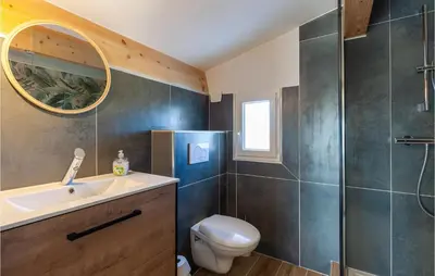 a bathroom with a sink and a toilet and a mirror at Beautiful Apartment In Eyragues in Eyragues