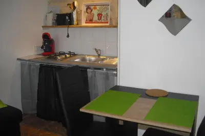a small kitchen with a sink and a table at Lou mas li Pitchoun 