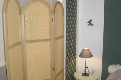 a room with a door with a lamp on a table at Lou mas li Pitchoun 
