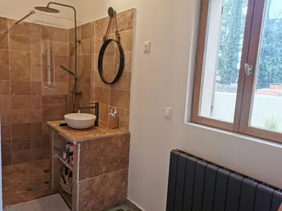 a bathroom with a sink and a shower at Maison de la bonne fontaine. in Lauris
