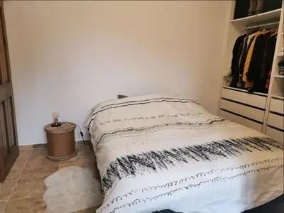 a bedroom with a bed and a closet at Maison de la bonne fontaine. in Lauris