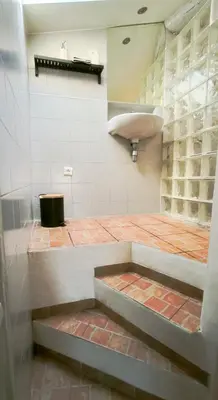 a room with a staircase in a building with a wall at Superbe T3 avec terrasse en plein cœur du centre historique in Aix-en-Provence