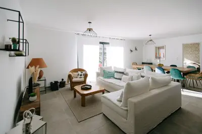a living room with a white couch and a table at La Dolce Vita Provençale Charming House with its Private Swimming Pool in LʼIsle-sur-la-Sorgue