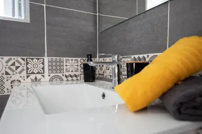 a bathroom sink with a yellow sponge next to a faucet at Le Duplex - Hypercentre - Wifi in Carpentras
