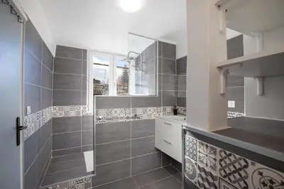 a bathroom with a walk in shower and a sink at Le Duplex - Hypercentre - Wifi in Carpentras