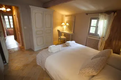 a bedroom with a large bed with two towels on it at La Petite Paradisse – mas provençal exceptionnel in Blauvac