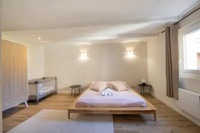 a bedroom with a bed with two pillows on it at L'antiquaire - 3 chambres - Hypercentre - Wifi in LʼIsle-sur-la-Sorgue