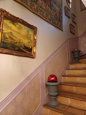 a painting hanging on a wall next to a staircase at Chambre d'hôte suite Tournesol 