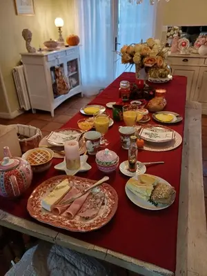 a table with plates of food and drinks on it at Chambre d'hôte suite Tournesol 