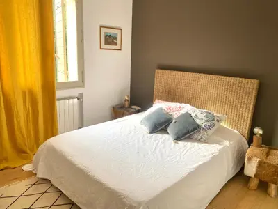 a bedroom with a bed with two pillows on it at Villa des Alpilles in Eygalières